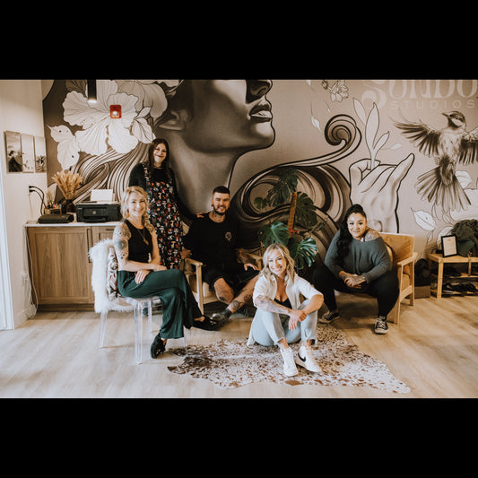 group of tattoo artists inside the Sundog Studios tattoo shop in Airdrie, Alberta