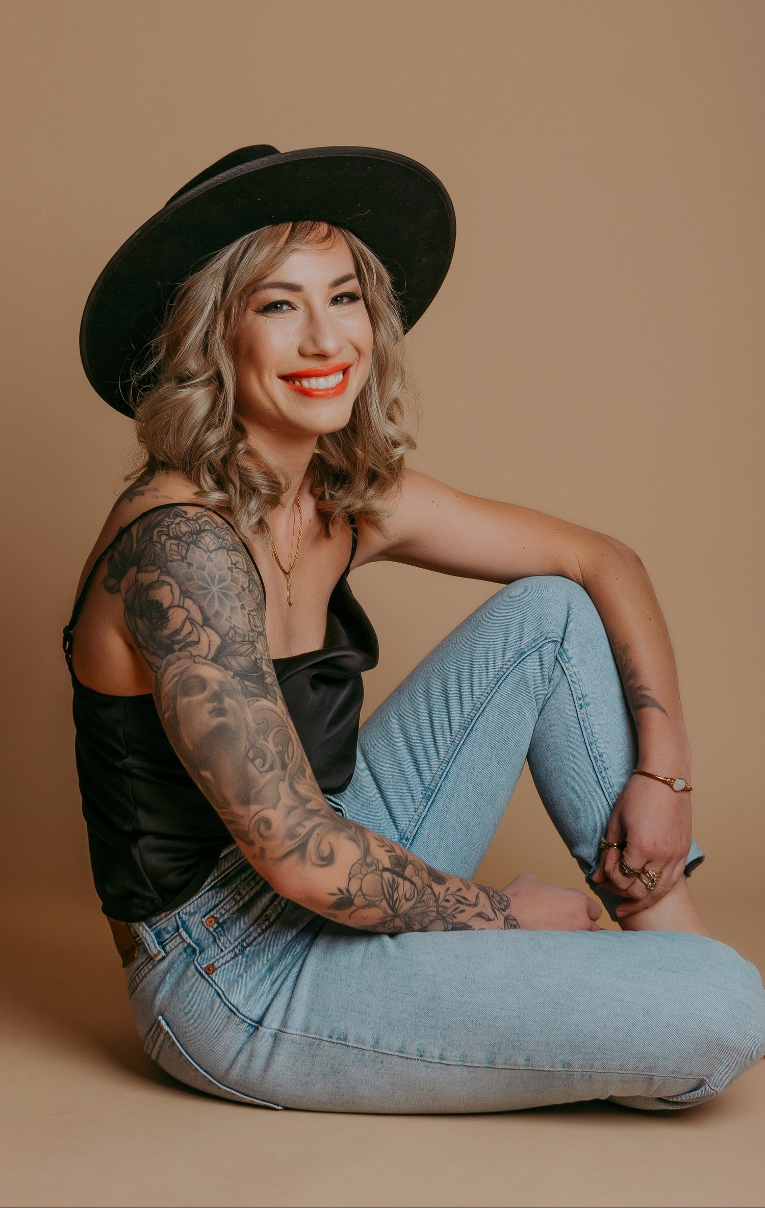 Tattoo artist Yvon_ink from Sundog Studios in Airdrie Alberta sitting with visible arm tattoos 