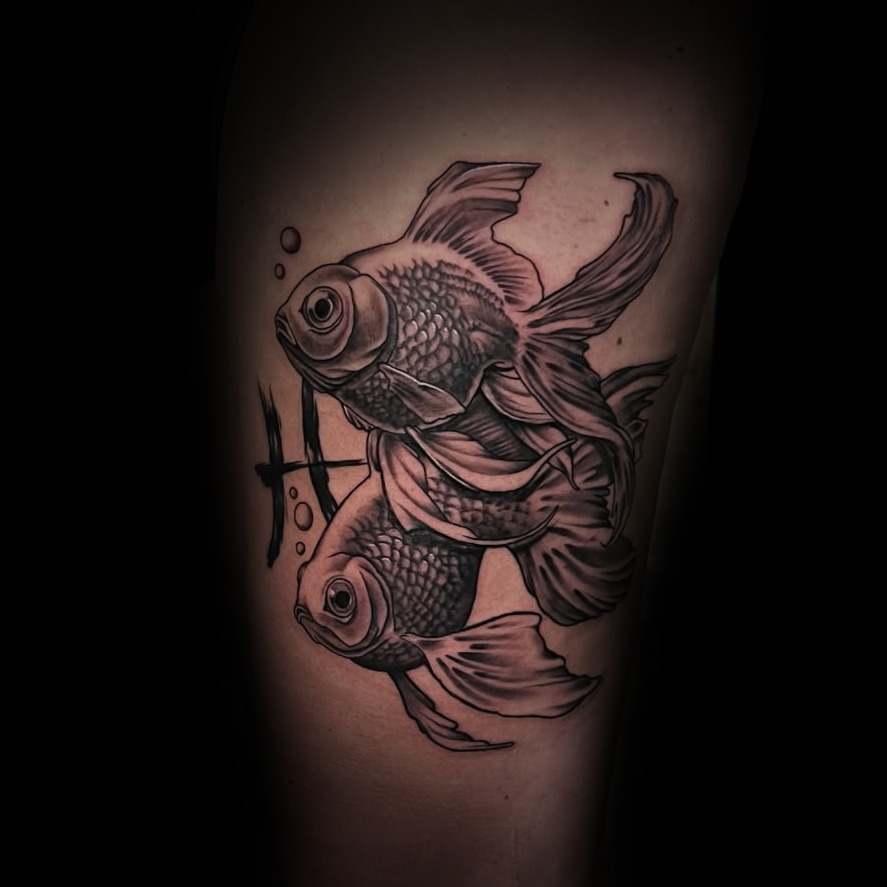 Black and gray tattoo of two gold fish by Dominic, tattoo artist at Sundog Studios in Airdrie Alberta