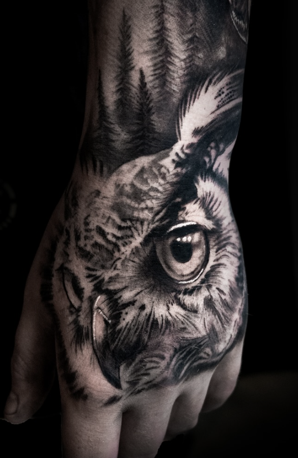 Black and grey realism owl hand tattoo with forest background by Yvon_ink at Sundog Studios in Airdrie Alberta
