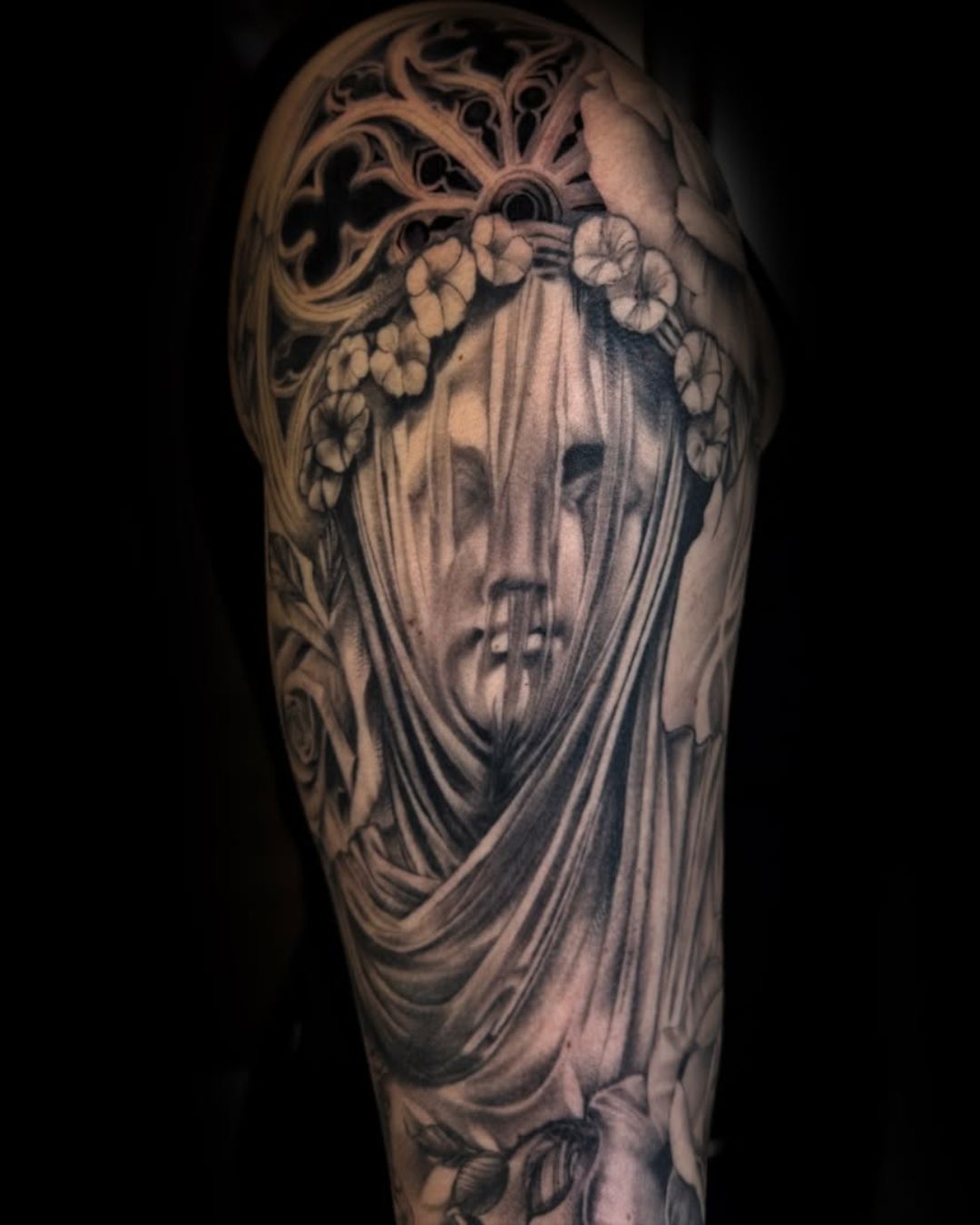 Black and grey realism veiled classical statue woman tattoo with flowers by Yvon_ink at Sundog Studios in Airdrie Alberta