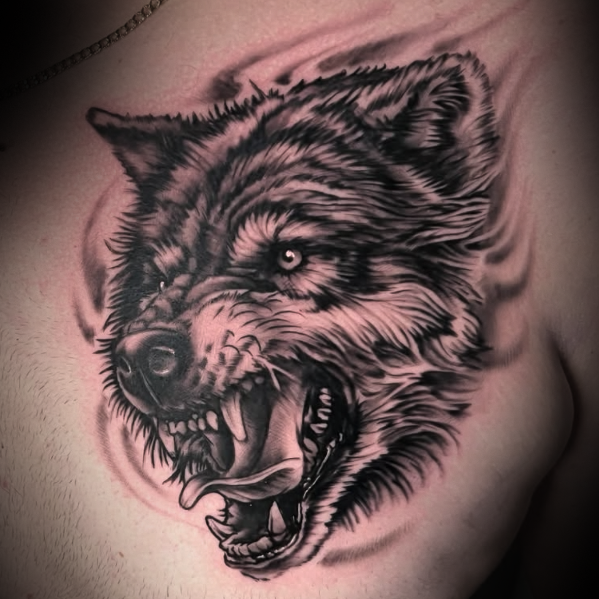 Black and gray tattoo of a wolf's head by Dominic, tattoo artist at Sundog Studios in Airdrie Alberta