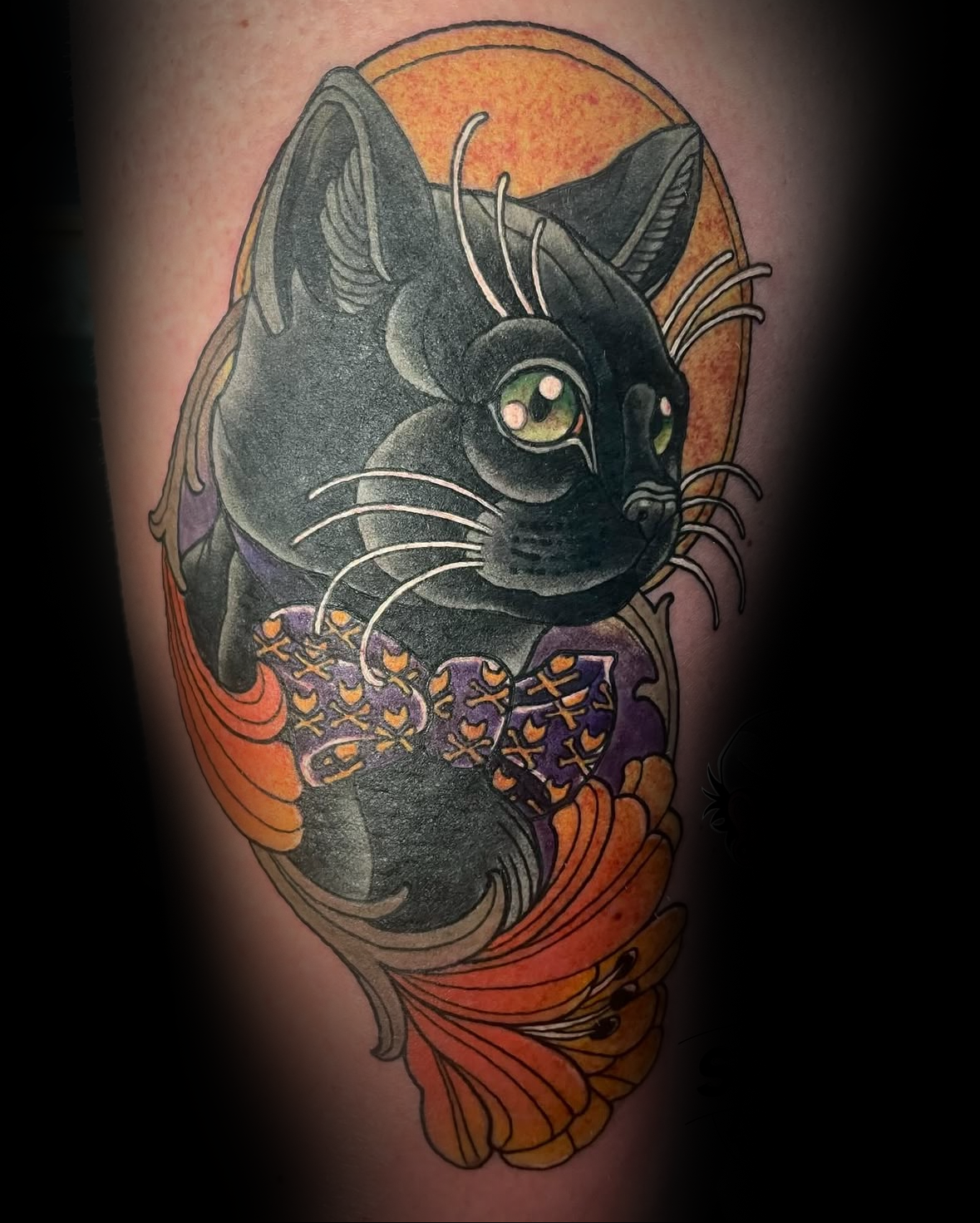 Detailed tattoo of a black cat with purple tie and colorful floral elements by Rob Adams, tattoo artist at Sundog Studios in Airdrie Alberta