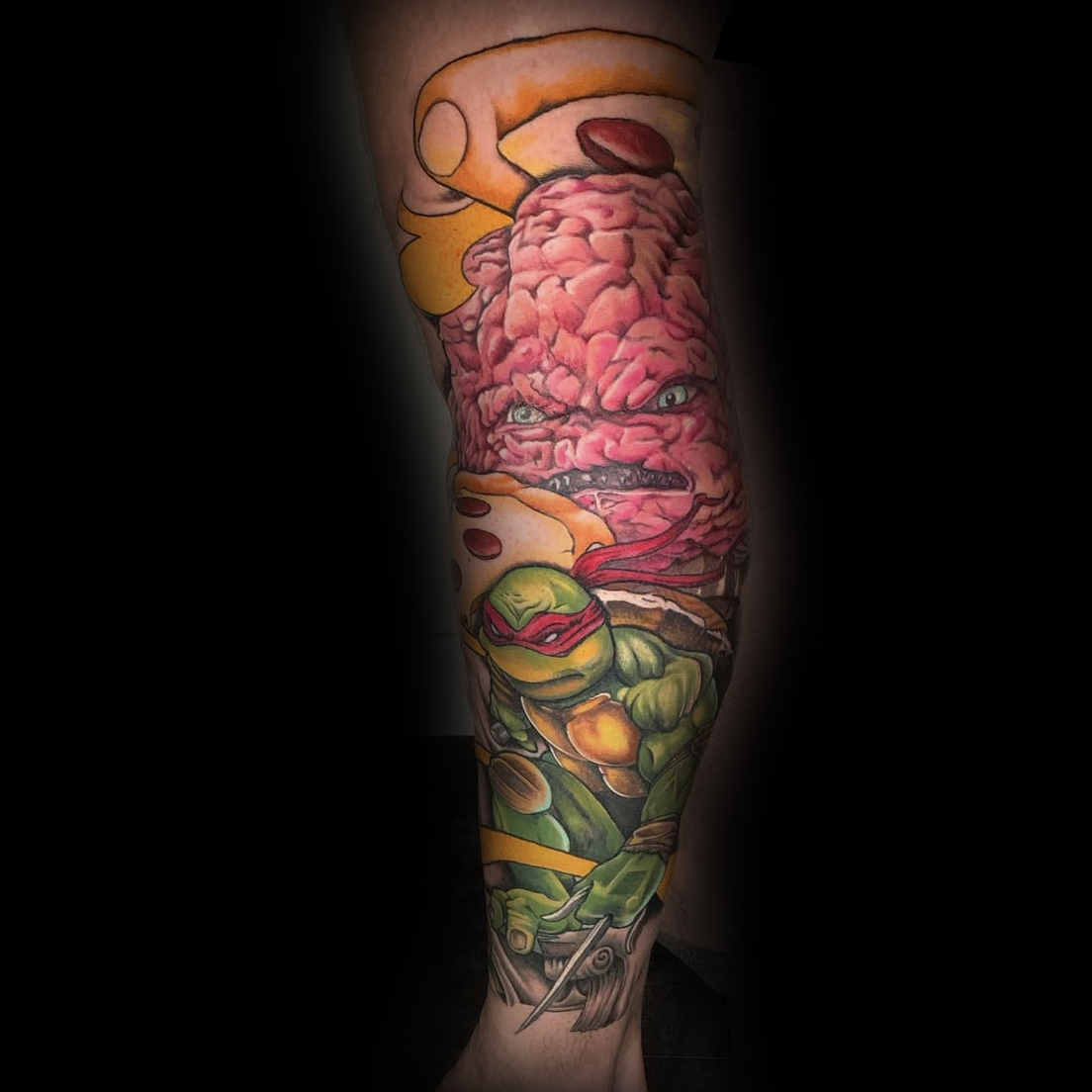 Colorful tattoo of a turtle character with a brain and other elements done by Dominic at Sundog Studios in Airdrie Alberta