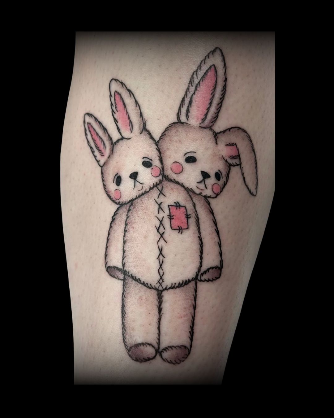 Tattoo of two cartoon-style bunnies, by Mahala, tattoo artist at Sundog Studios in Airdrie Alberta