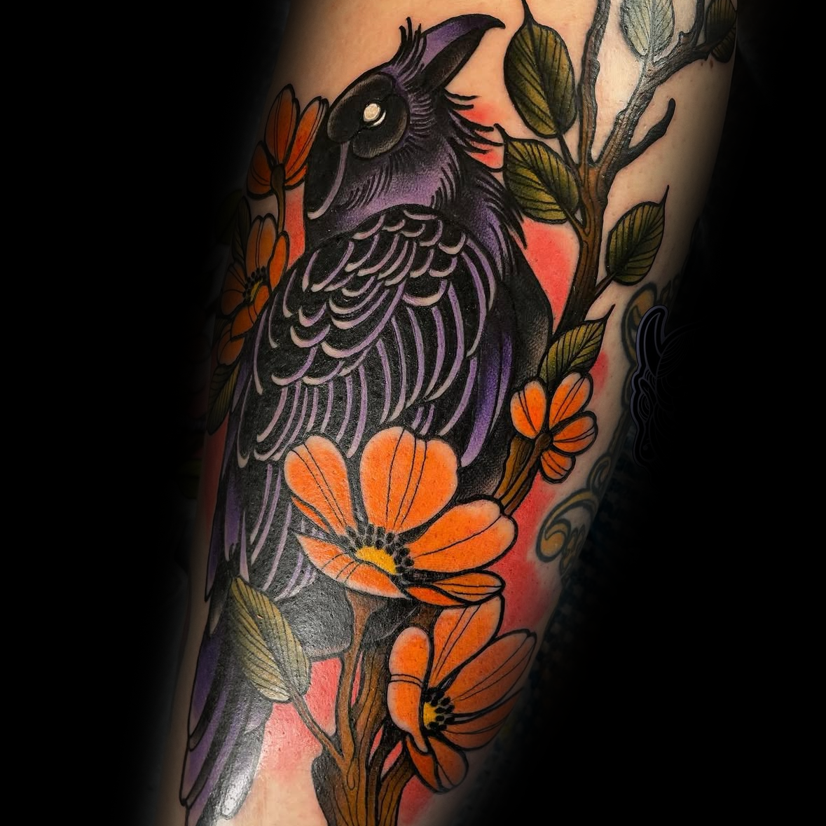 Colorful tattoo of a bird and flowers on by Rob Adams, tattoo artist at Sundog Studios in Airdrie Alberta