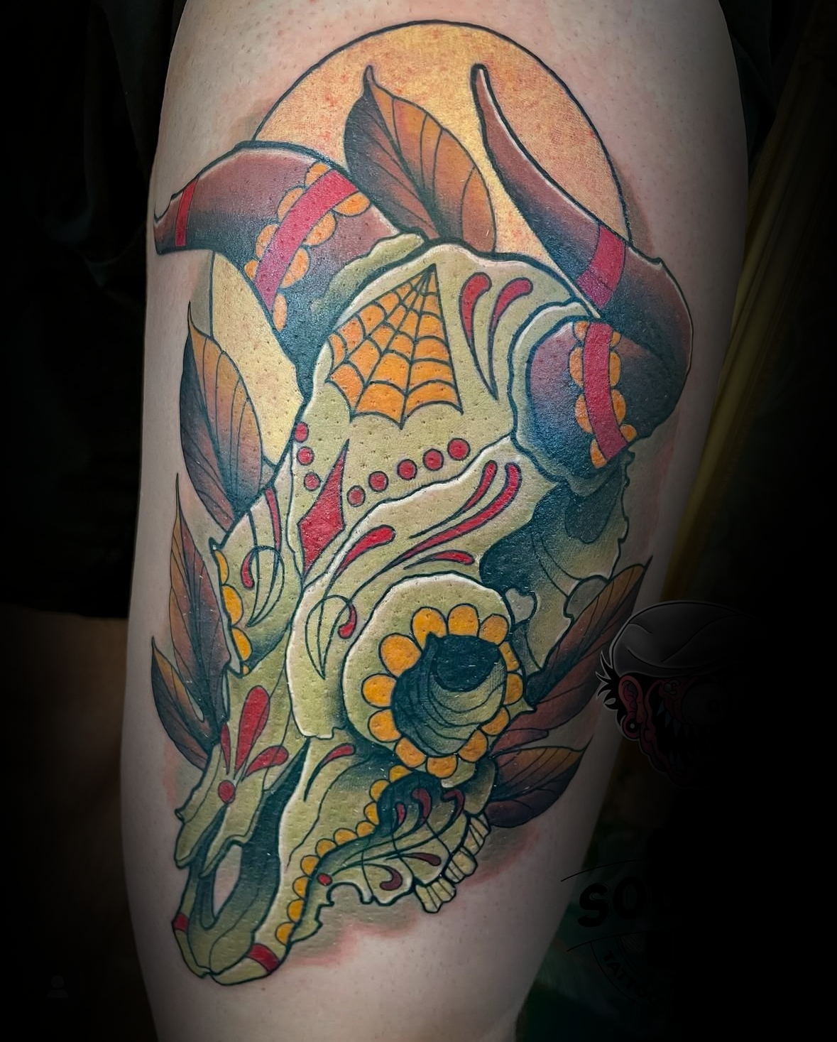 Colourful tattoo of a deer skull with intricate patterns on a person's arm by Rob Adams, tattoo artist at Sundog Studios in Airdrie Alberta