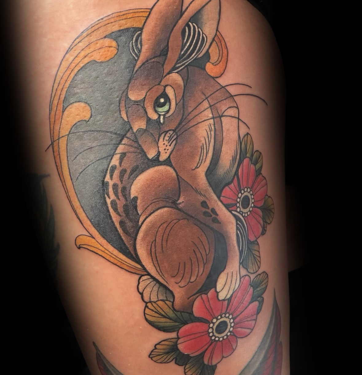 Colourful tattoo of a rabbit and flowers on a person's arm by Rob Adams, tattoo artist at Sundog Studios in Airdrie Alberta