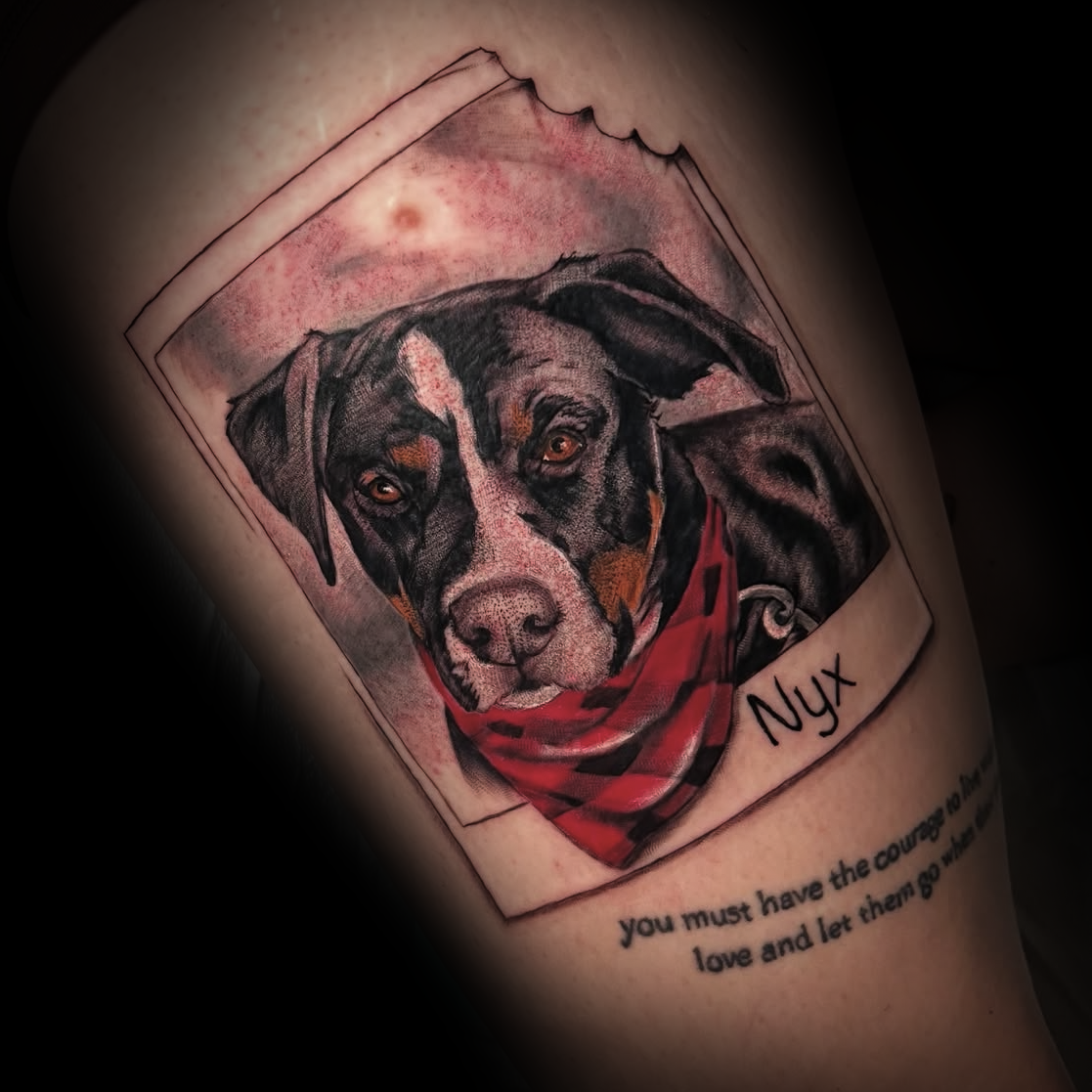 Tattoo of a dog with a red bandana and the name 'Nyx' by Dominic, tattoo artist at Sundog Studios in Airdrie Alberta