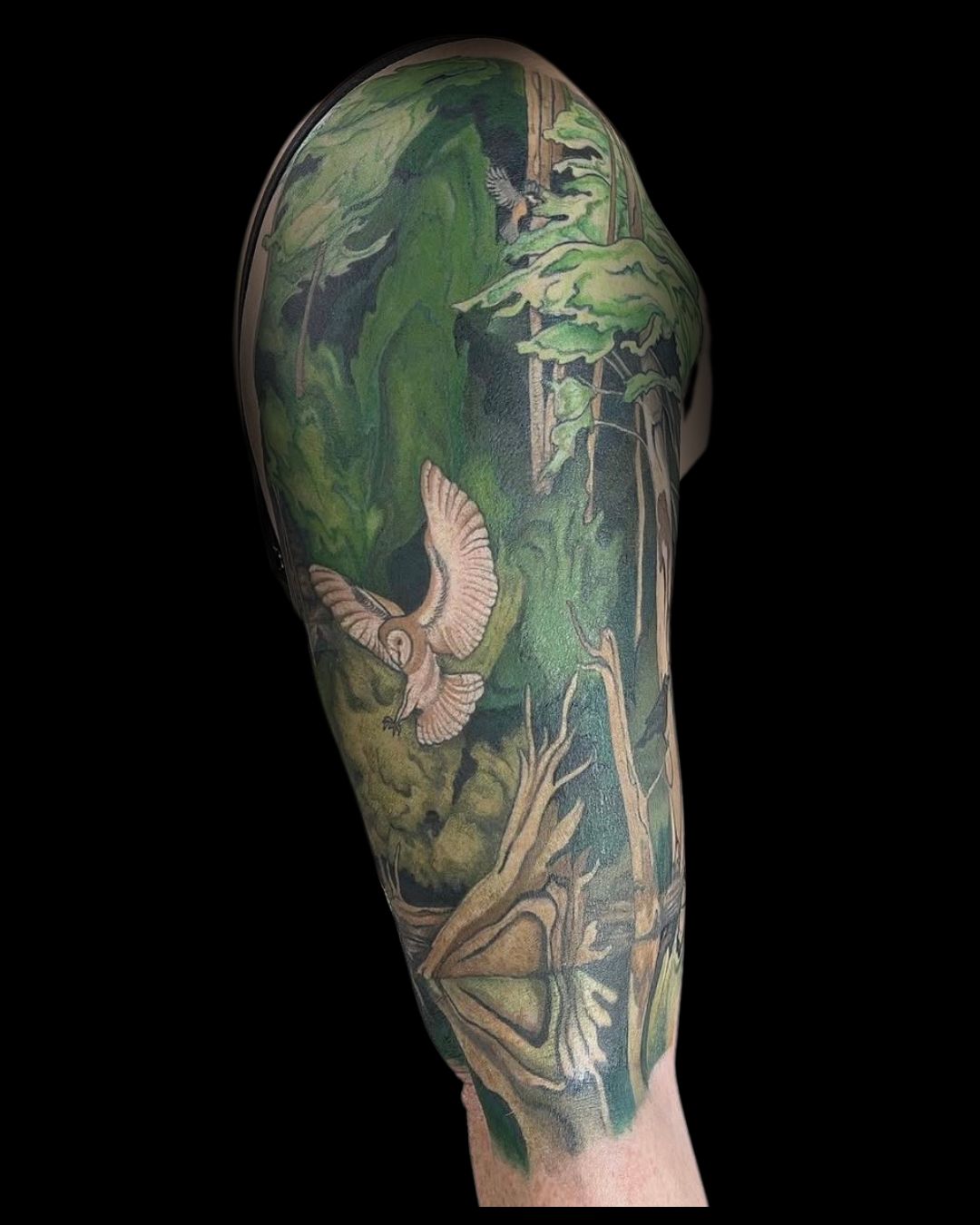 Full sleeve tattoo of a forest scene with an owl by Mahala, tattoo artist at Sundog Studios in Airdrie Alberta