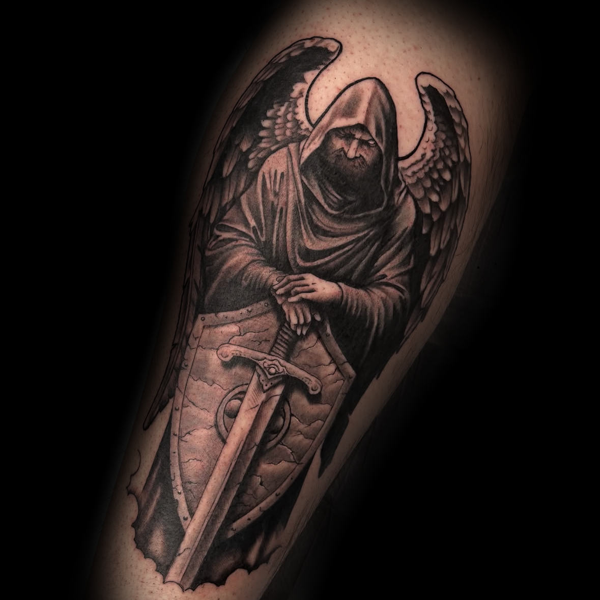 Tattoo of a hooded man with wings and a sword by Dominic, tattoo artist at Sundog Studios in Airdrie Alberta