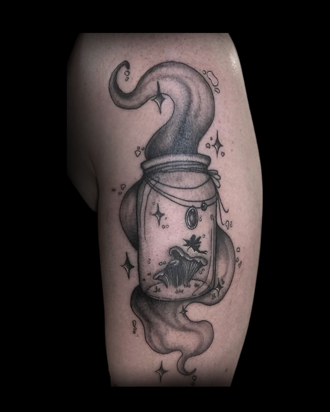 Tattoo of a jar with different elements on a person's arm by Mahala, tattoo artist at Sundog Studios in Airdrie Alberta