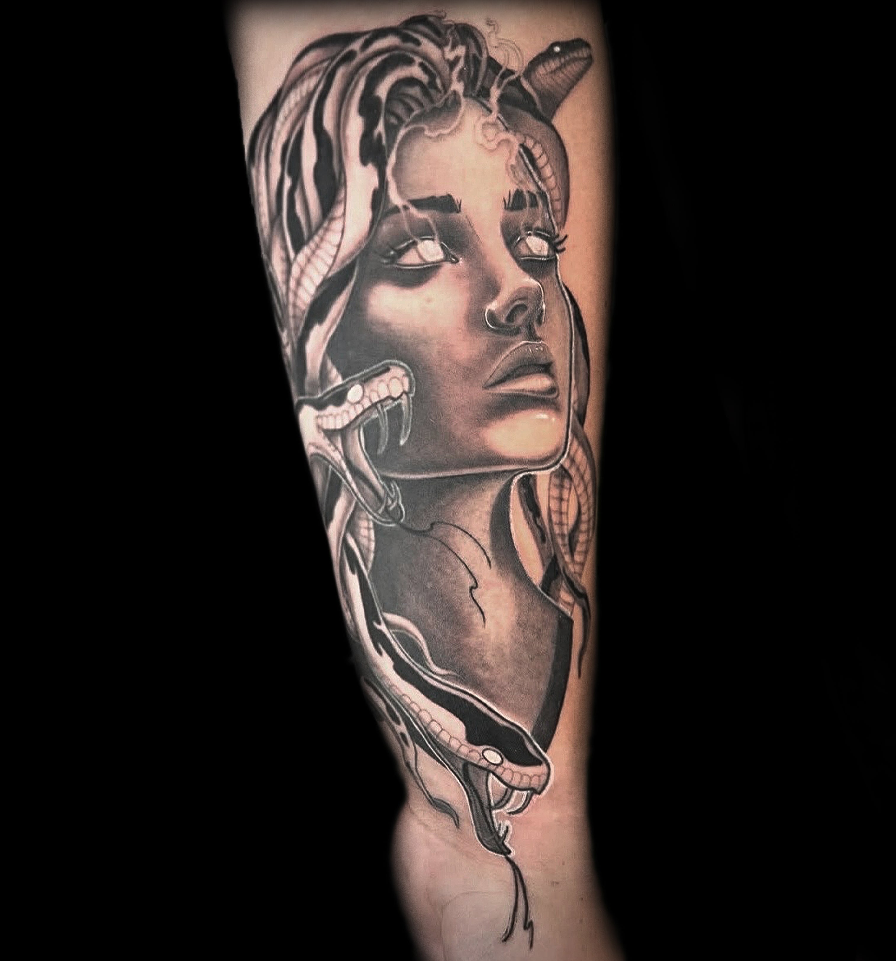 black and grey realism medusa forearm tattoo with snakes by Sundog Studios tattoo artists in Airdrie Alberta