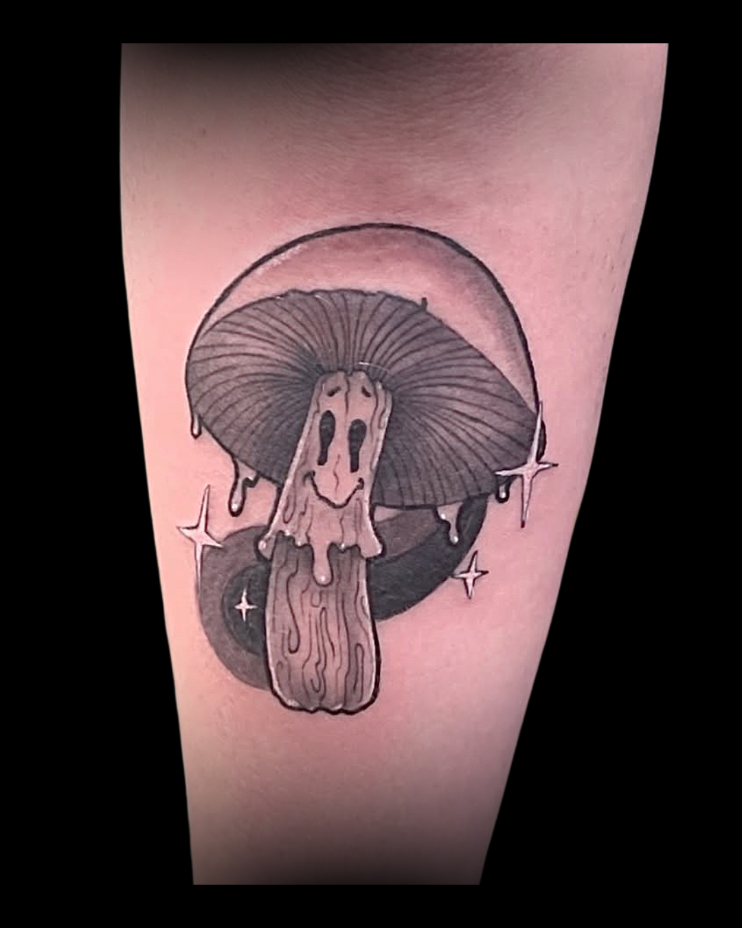 Tattoo of a smiling mushroom with a cap resembling a ghost on a person's arm done by Channy at Sundog Studios in Airdrie Alberta