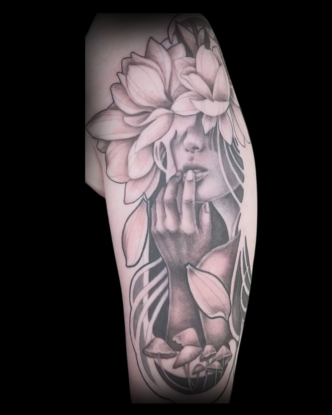 Tattoo of a woman with flowers on her head and face, covering a person's arm by Channy, tattoo artist at Sundog Studios in Airdrie Alberta